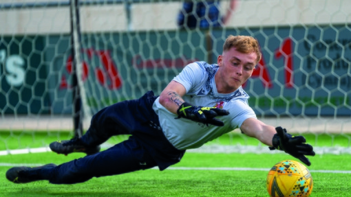 Goalkeeper making a save on the 3G pitch