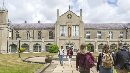 students walking through Lampeter campus grounds towards each other