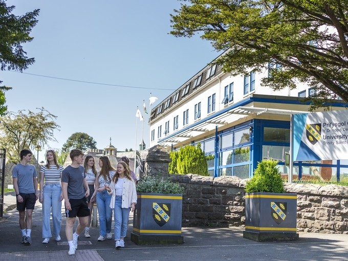 students walking through carmarthen town