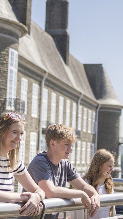 students overlooking carmarthen town view with grey town council building backdrop