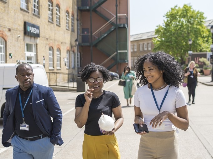 Three students walking in London