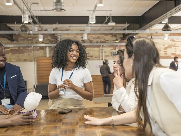 students around a table in London campus