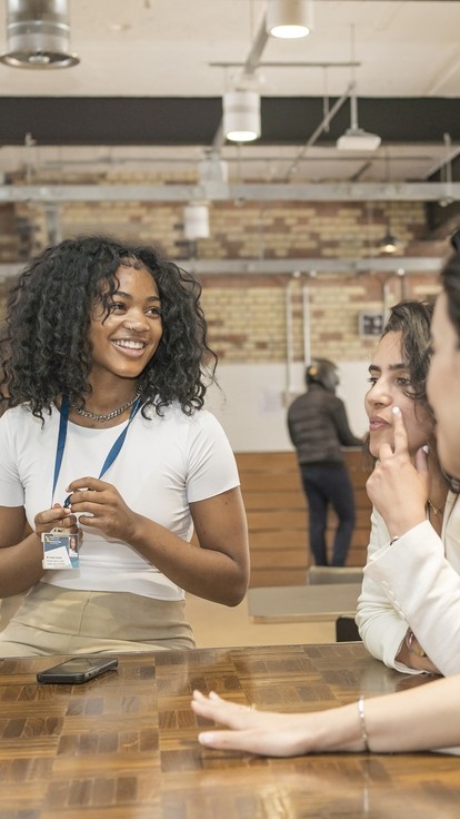 students around a table in London campus