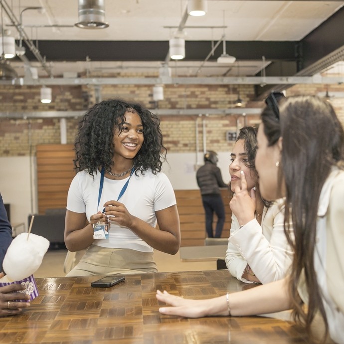 students around a table in London campus