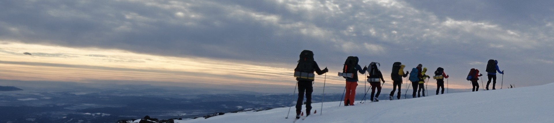 Students walking on snow-capped mountain