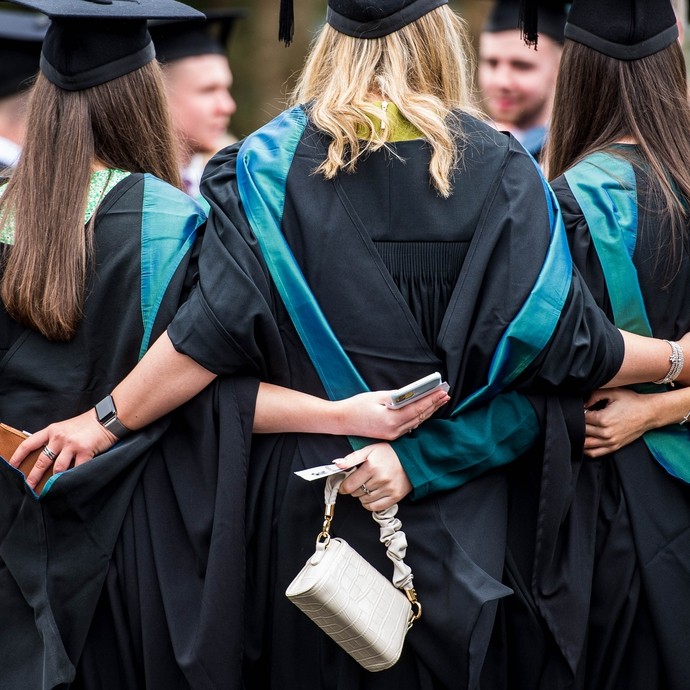 Group of students hugging at their graduation