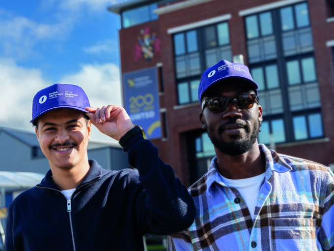 Students wearing purple SU caps