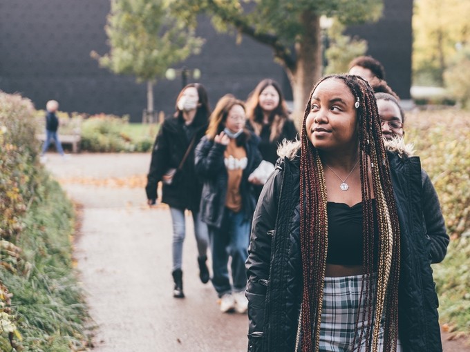 Row of students walking on a path