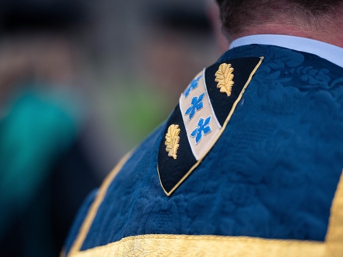 UWN badge on the back of a robe