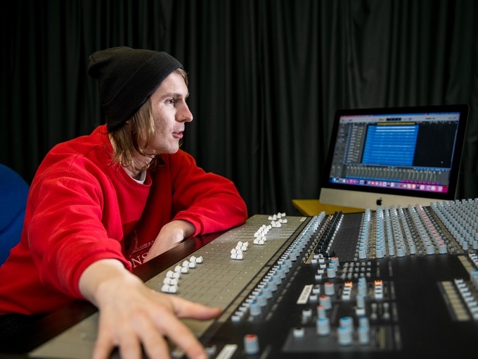 Student working on a sound mixer