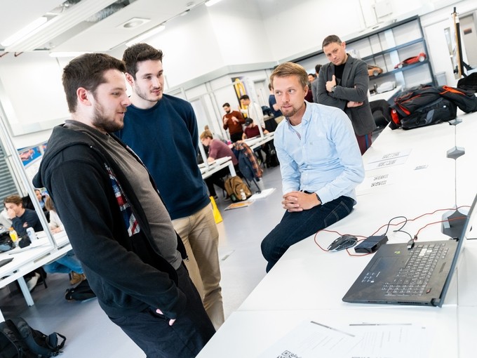 Visiting student giving advice to current students