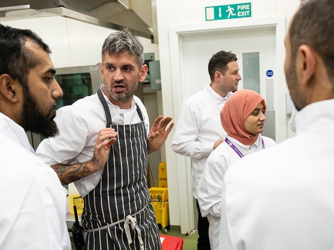 Chef and kitchen staff in discussion