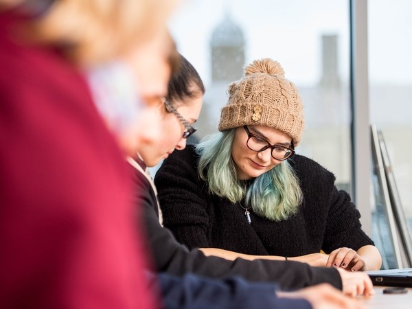 Students collaborating at a desk