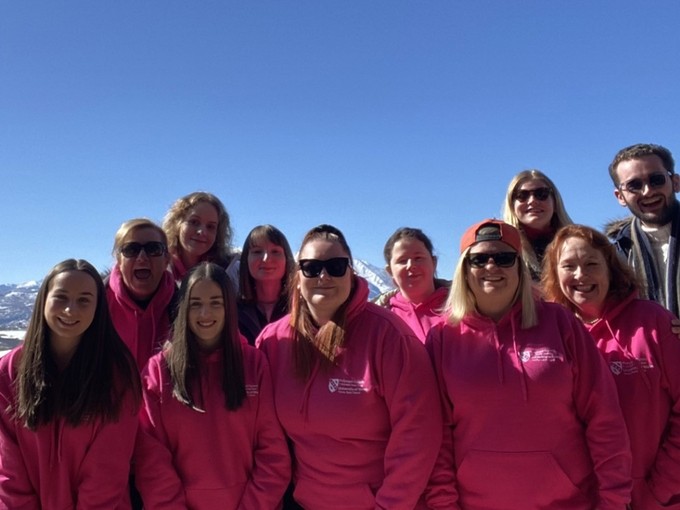 Group of students wearing pink branded UWN hoodies