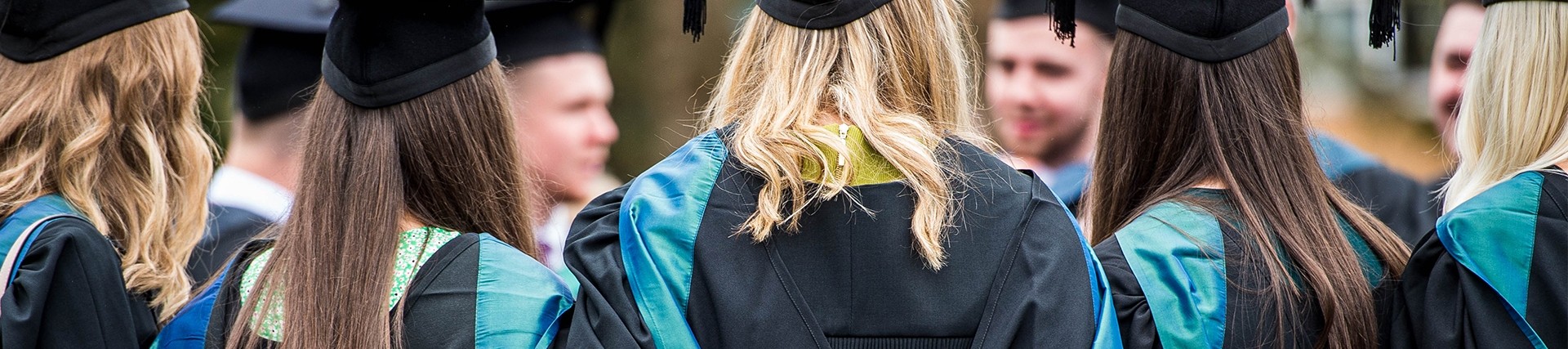 Group hugging at their graduation