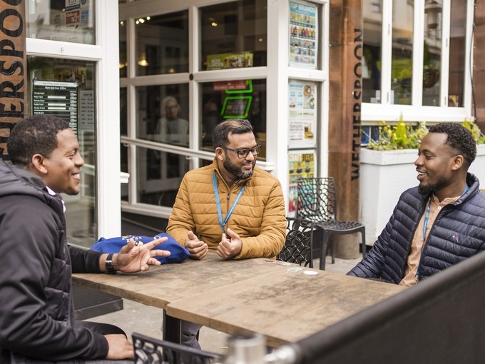 Students socialising at an outside bar table