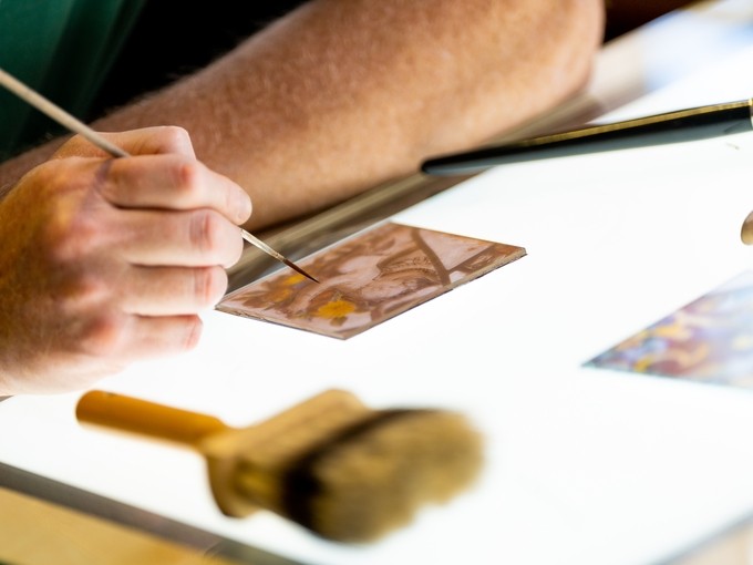 Student working on a piece of stained glass
