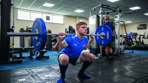Student weightlifting in the gym