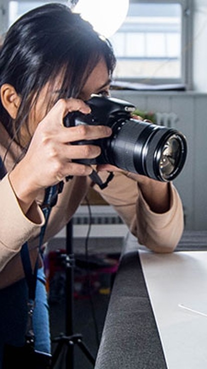 Student taking a photo in studio