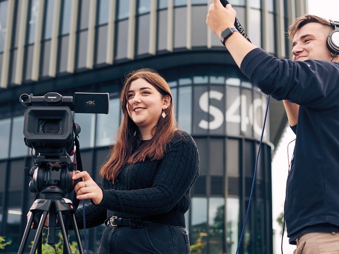 Students filming outside Canolfan S4C Yr Egin