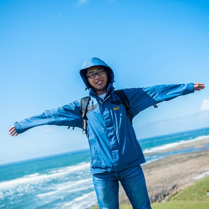 Student standing with his arms wide open